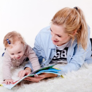 An apprentice with a child, teaching them to read